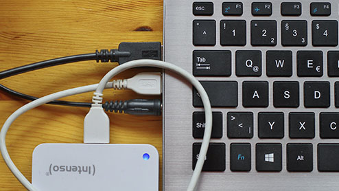 Cords and devices plugged into computer ports