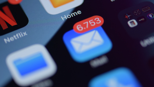 Close-up of Outlook unread message envelope icon on a device