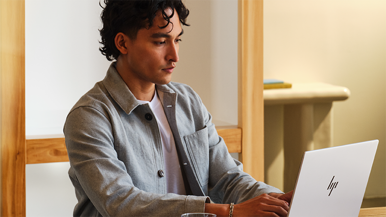 A young professional looks up identity theft protection on his laptop